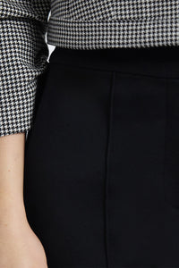 Person wearing a black and white checkered shirt with a black Pant