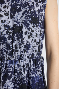 Close-up of a sleeveless top with a blue floral pattern on a white background