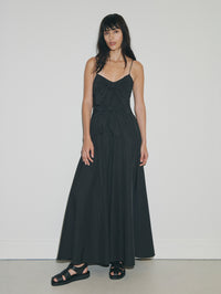 Woman wearing a black dress against a white background