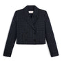 A cropped double-breasted blazer in a dark navy and black plaid pattern, featuring notched lapels and front flap pockets, shown against a plain white background.