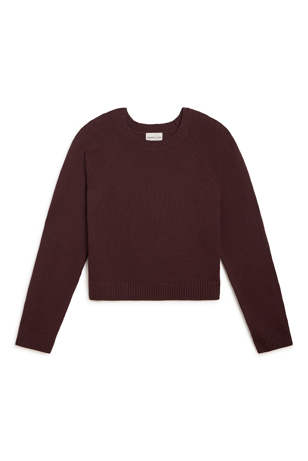 A dark burgundy knit long-sleeve crop sweater with raglan sleeves, laid flat against a solid white background.