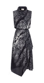 A sleeveless high-neck midi dress with an abstract black and white spotted pattern, featuring a wrap-style skirt and asymmetrical hemline, shown against a plain white background.