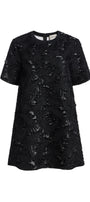 A black short-sleeve tunic dress with a textured, distressed lace-like pattern, shown against a plain white background.