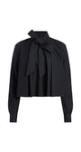 A black long-sleeve blouse with a high collar and a large bow tied at the front, shown on a plain white background.