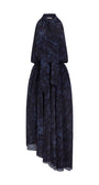 A sleeveless dark navy blue and black abstract patterned dress with a high collar, tie neckline, and asymmetrical draped skirt, shown on a plain white background.