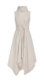 A sleeveless high-neck midi dress in a light cream or off-white color, featuring a self-tie waist belt and an asymmetrical draped hemline, shown against a plain white background.