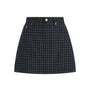 A dark navy and black plaid mini skirt with silver button details on the front waistband, shown flat against a white background.