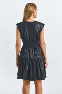 Black leather dress worn by a model on a white background