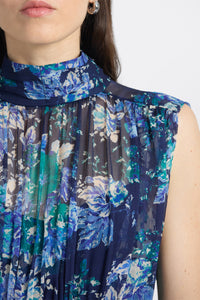 Close-up of a sleeveless top with blue floral pattern on a white background